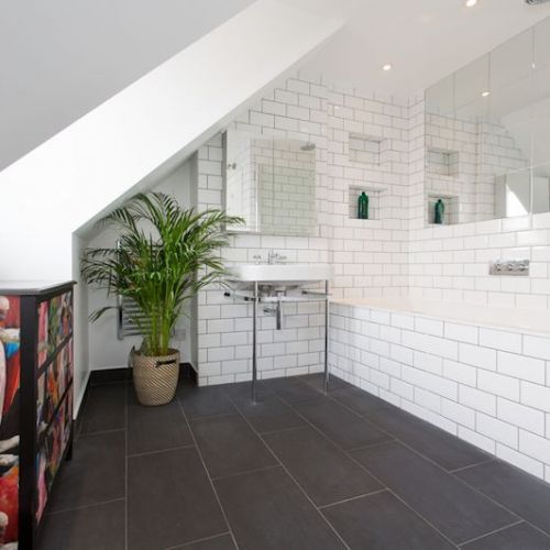 Dormer loft conversion with a large bathroom with bath, creating a really nice space